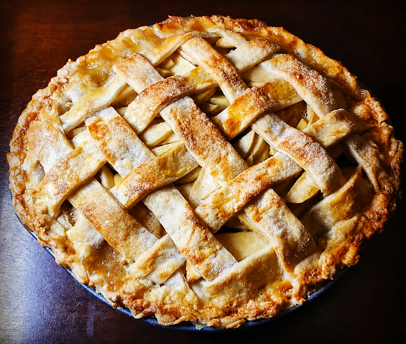 A freshly baked lattice-top apple pie with a deeply golden crust